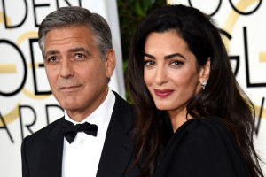 Actor George Clooney (L) and Amal Clooney arrive on the red carpet for the 72nd annual Golden Globe Awards, January 11, 2015 at the Beverly Hilton Hotel in Beverly Hills, California. AFP PHOTO/MARK RALSTONMARK RALSTON/AFP/Getty Images